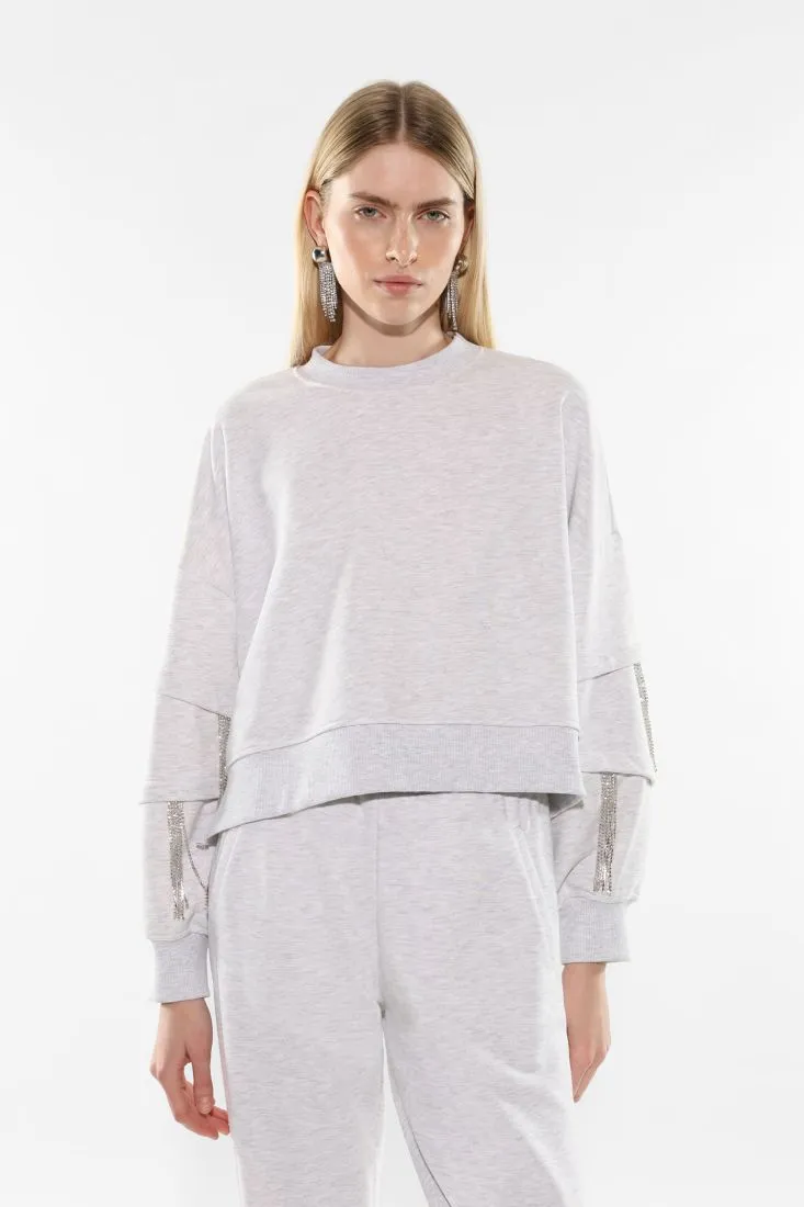 Felpa oversize con frange di strass sulle maniche