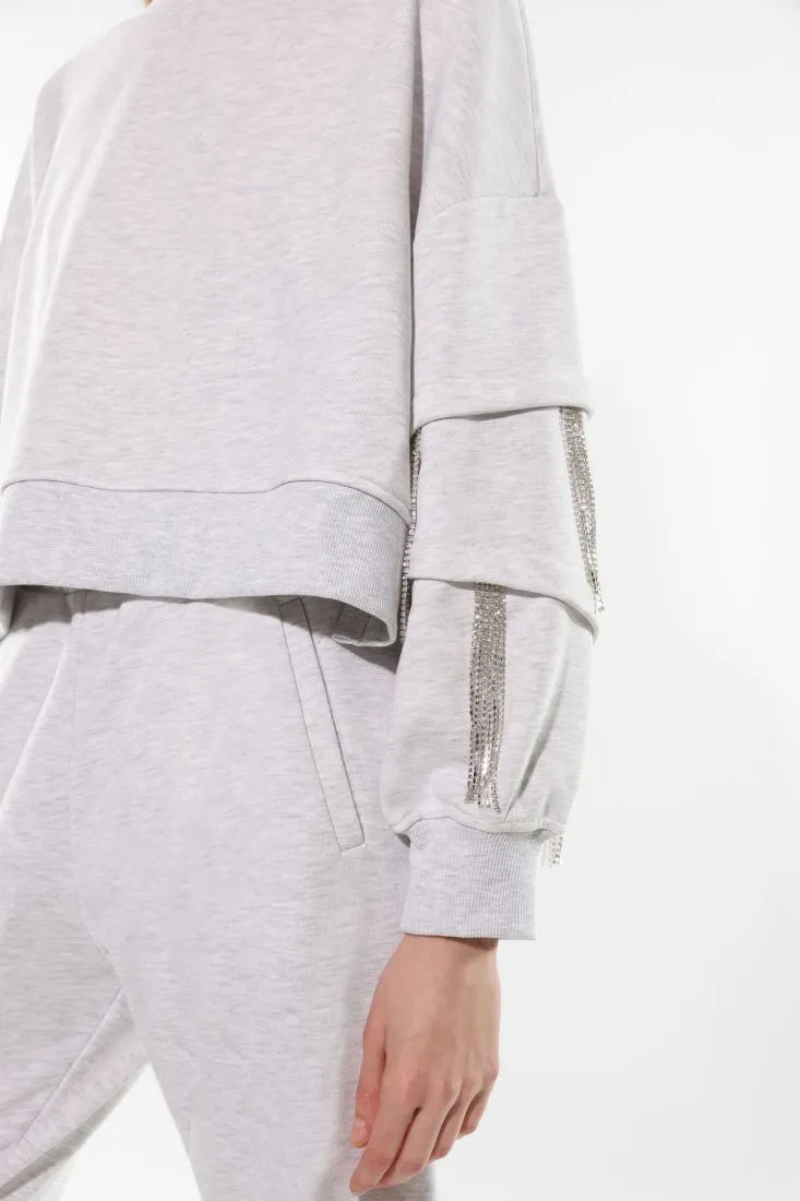 Felpa oversize con frange di strass sulle maniche